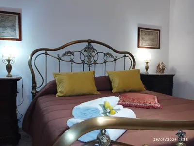 a bed with towels and pillows on top of it at La casa di Nanà IL BAGLIO in Palermo