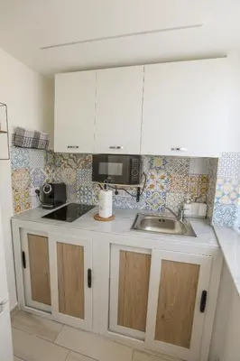 a refrigerator with sunglasses on it in a kitchen at Gioiamia Luxury Apartment in Palermo