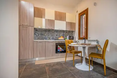 a kitchen with a table and chairs in a room at Casa del Golfo Cascio in Castellammare del Golfo