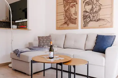 a living room with a white couch and a table at Ciao Sycylia Apartments in Carini