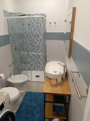 a bathroom with a toilet and a sink and a shower at RineddaHouse Arenella - Vista Mare Panoramica a Palermo con Parcheggio privato in Palermo