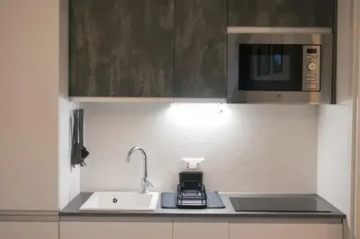 a kitchen with a sink and a microwave at La casa di Louis in Palermo