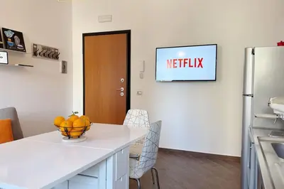 a kitchen with a table with a bowl of fruit on it at Molo Five Apartment in Palermo