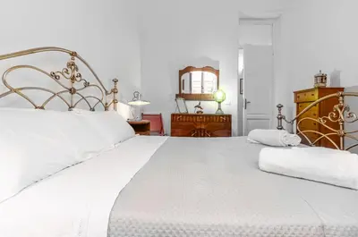 a large white bed with two pillows on it at GuestHost - Near Palermo's Historic Heart - Apt with Courtyard in Palermo