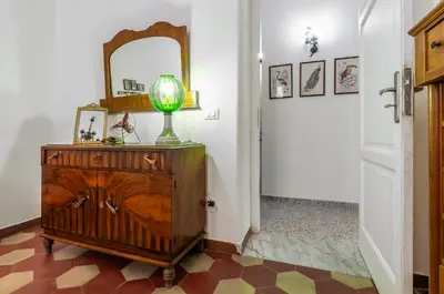 a mirror on top of a dresser in a hallway at GuestHost - Near Palermo's Historic Heart - Apt with Courtyard in Palermo