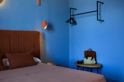 a blue room with a bed and a blue wall at Belmonte LR Collection in Palermo