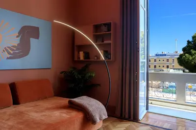 a living room with a floor lamp next to a window at Belmonte LR Collection in Palermo