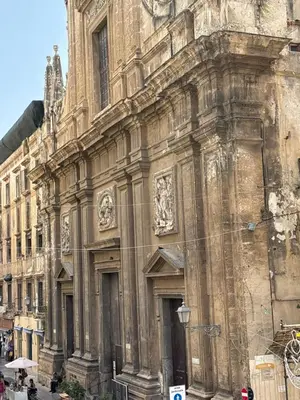 an old stone building with a street light in front of it at Ai Crociferi affittacamere in Palermo