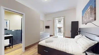 a bedroom with a bed and a sink and a mirror at Ai Crociferi affittacamere in Palermo