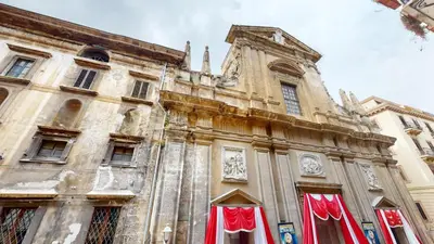 an old building with red curtains in front of it at Ai Crociferi affittacamere in Palermo