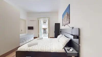 a bedroom with a large bed in a room at Ai Crociferi affittacamere in Palermo
