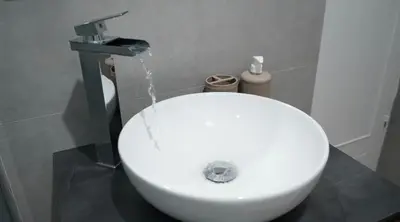 a white toilet in a bathroom with water fountain at Licia's home in Palermo