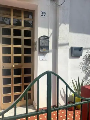 a door with a clock on the side of a building at Licia's home in Palermo