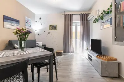 a dining room and living room with a table and chairs at GuestHost - Palermo Charming Flat with Terraces x6 in Palermo
