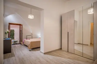 a bedroom with a bed and a large closet at Casa Del Golfo SantAntonino in Castellammare del Golfo
