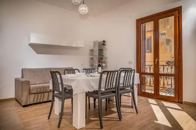 a dining room with a table and chairs and a couch at Casa Del Golfo SantAntonino in Castellammare del Golfo