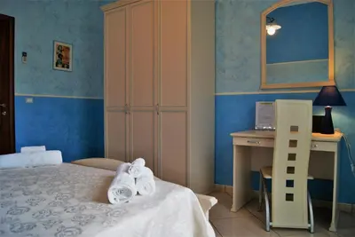 a bedroom with a bed and a desk with towels at la Maison 
