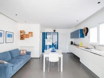a living room with a blue couch and a table at Villa Timpi Rossi Total Relax in Alcamo