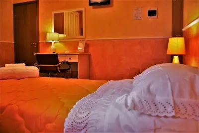 a bedroom with a bed and a desk and a chair at B&B Oleaster - Bolognetta in Bolognetta