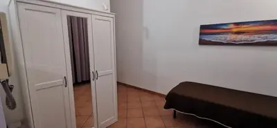a bedroom with a bed and a painting on the wall at Casa Bellini in Palermo