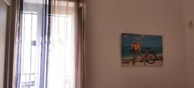 a picture of a bike on a wall next to a window at Casa Bellini in Palermo