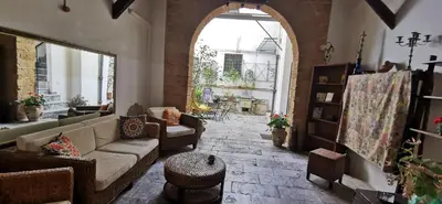 a living room with a couch and a large window at Casa Bellini in Palermo