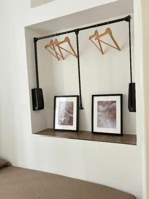 a mirror hanging on a wall with two pictures at Come fossi a casa in Palermo