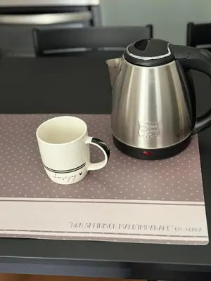 a coffee pot and a cup sitting on a box at Come fossi a casa in Palermo