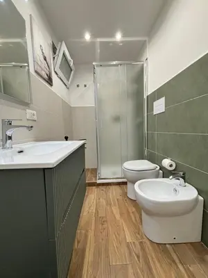 a bathroom with a sink and a toilet and a shower at Come fossi a casa in Palermo