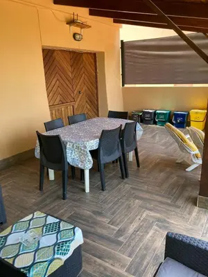 a dining room with a table and chairs at Villa Chifeci Scopello - Appartamento Verde in Scopello