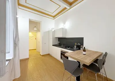 a kitchen with a table and chairs in a room at Solemar Sicilia - Casa Markiz in Palermo