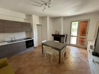 a kitchen with a table and a dining room at Villa Chifeci Scopello - Appartamento La Zàgara in Scopello
