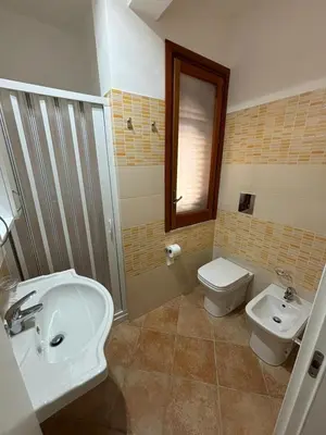 a bathroom with a sink and a toilet at Villa Chifeci Scopello - Appartamento La Zàgara in Scopello