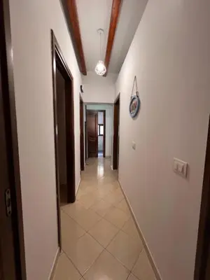 a hallway with white walls and a tile floor at L'Aurora in Porticello