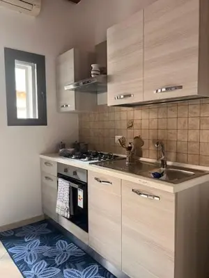 a kitchen with a sink and a stove top oven at L'Aurora in Porticello