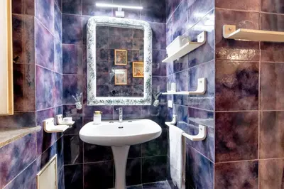 a bathroom with a toilet and a sink and a shower at Palazzo del Bono suites in Palermo