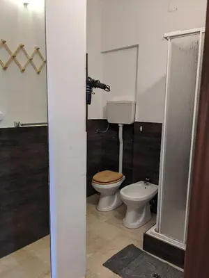 a bathroom with a toilet and a shower stall at Rosalba apartments - cheap and characteristic in Palermo