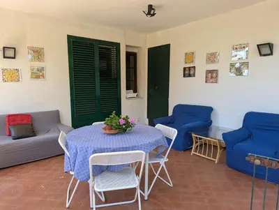 a room with a table and chairs and a couch at Rosalba apartments - cheap and characteristic in Palermo