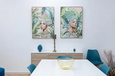 a dining room with three paintings on the wall at Casa Gaia in Terrasini