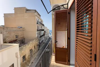 an open door to a balcony with a view at Casa Gaia in Terrasini