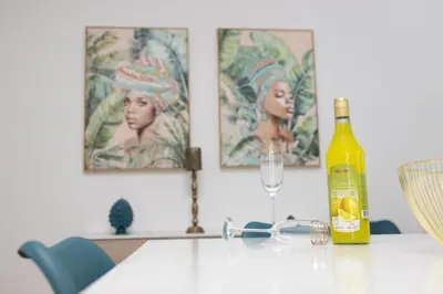 a bottle of wine sitting on a table with a glass at Casa Gaia in Terrasini
