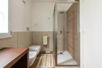 a bathroom with a toilet and a glass shower at Villa Giovanna con Piscina by Wonderful Italy in Castellammare del Golfo