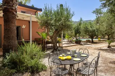 a table and chairs in the yard of a house at Villa Giovanna con Piscina by Wonderful Italy in Castellammare del Golfo