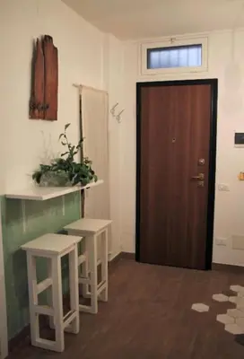 a room with a door and two stools in front of it at Porta delle Stelle Vucciria in Palermo