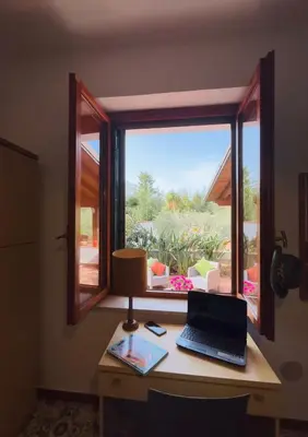 a desk with a window with a laptop on it at Casa a Mare La Stalletta in Palermo