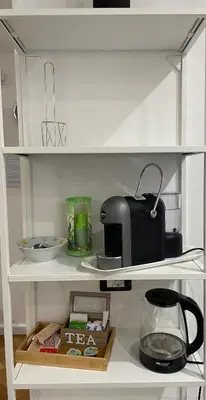 a kitchen shelf with a toaster and a bowl and a toaster at Baaria house in Bagheria