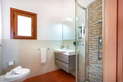 a bathroom with a toilet and a sink and a shower at Villa Acquamarina - 300 meters from the sea in Scopello