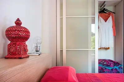 a red object sitting on a dresser in a bedroom at Villa Acquamarina - 300 meters from the sea in Scopello