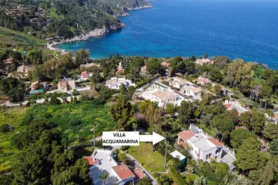 an aerial view of a house on a hill next to the water at Villa Acquamarina - 300 meters from the sea in Scopello