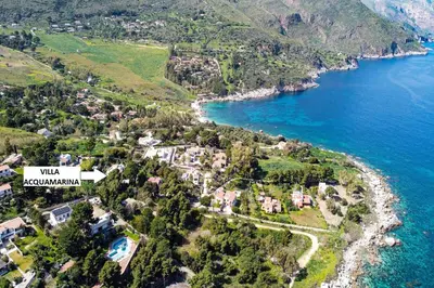 an aerial view of a village on the shore of a lake at Villa Acquamarina - 300 meters from the sea in Scopello